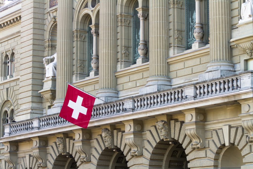 Bundeshaus Facade with Swiss Flag in Bern